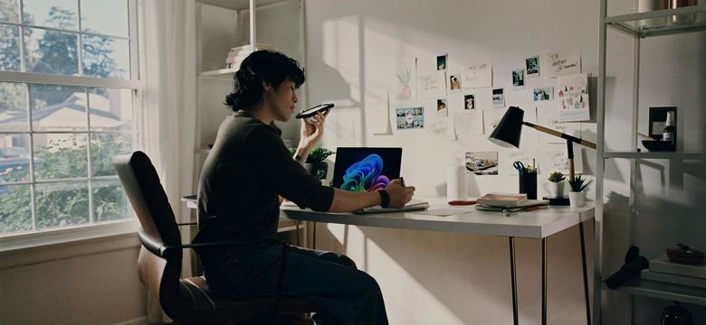 Person working at desk with laptop and phone